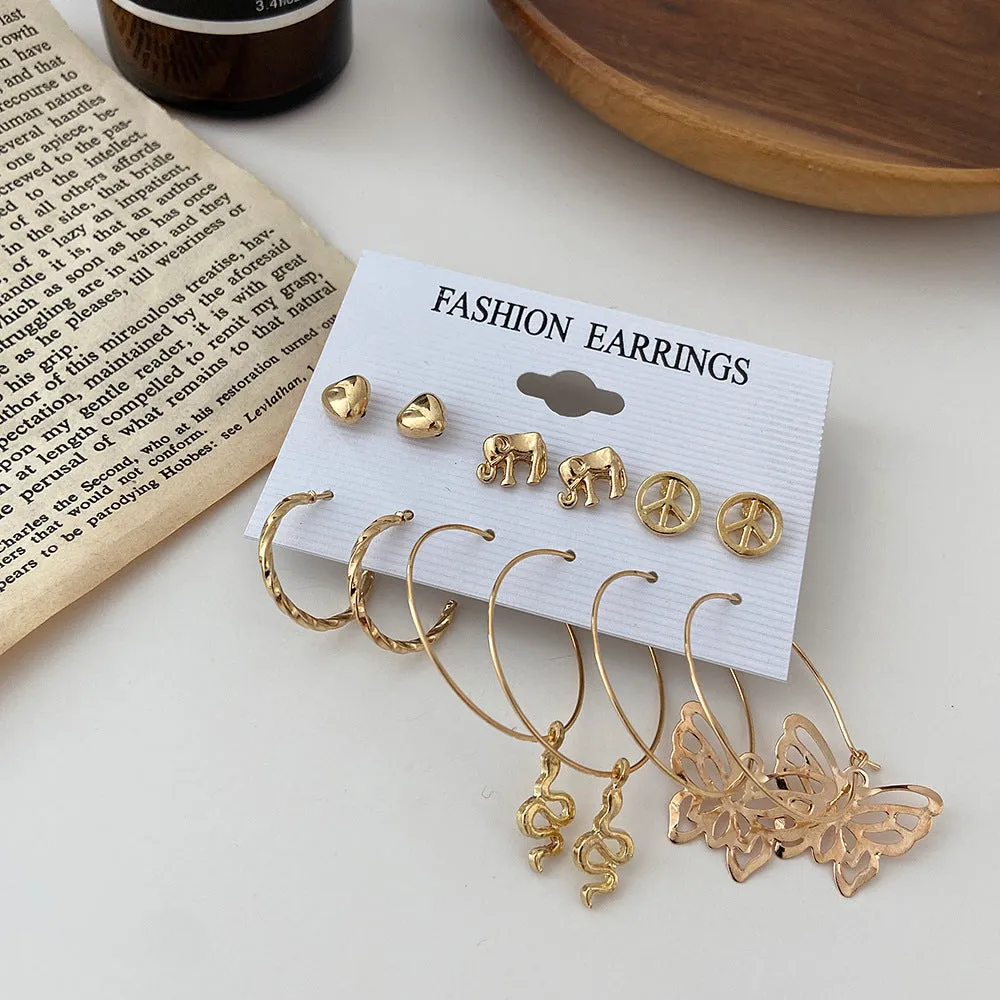 Nine pairs of gold alloy earrings with butterfly and love designs arranged together