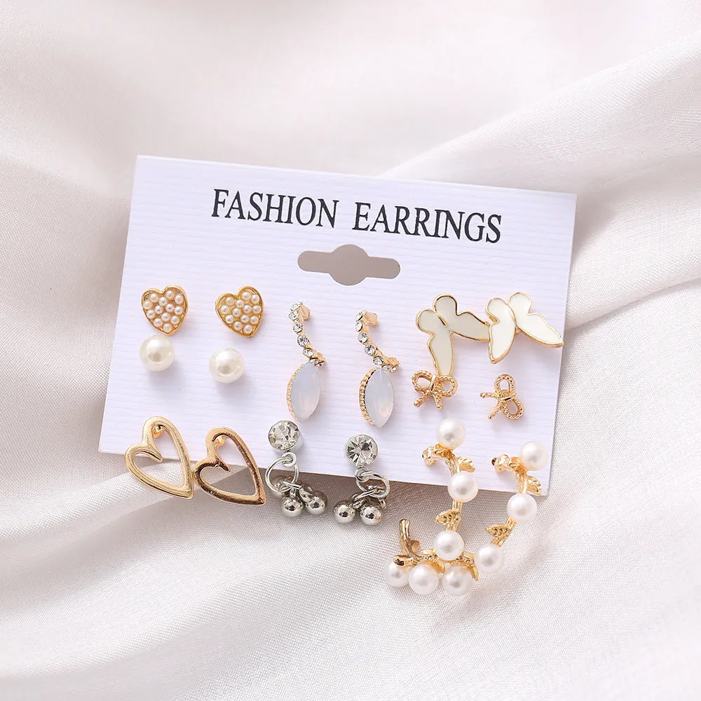 Nine pairs of gold alloy earrings with butterfly and love designs arranged together
