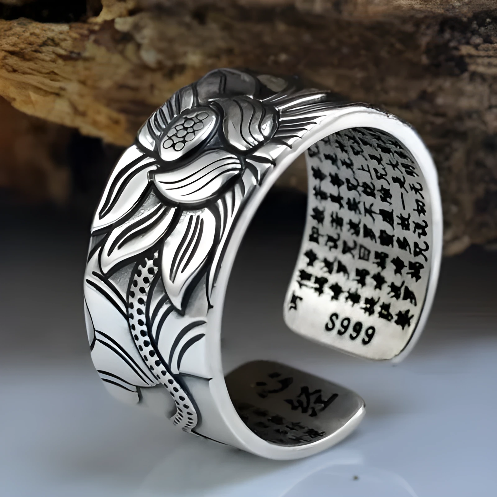 Thai silver black Lotus Heart Sutra ring with retro geometric pattern and matte oiling finish on grey background