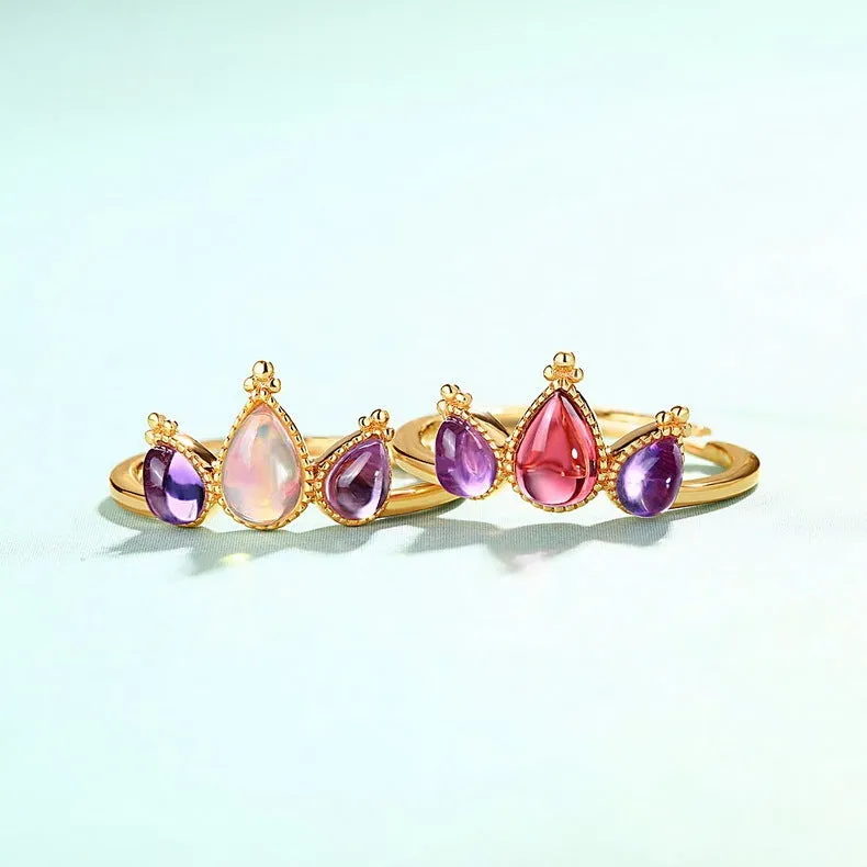 Sterling silver ring with drop-shaped garnet stone on finger, 925 silver, electroplated finish