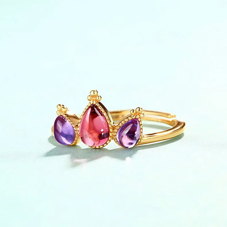 Sterling silver ring with drop-shaped garnet stone on finger, 925 silver, electroplated finish