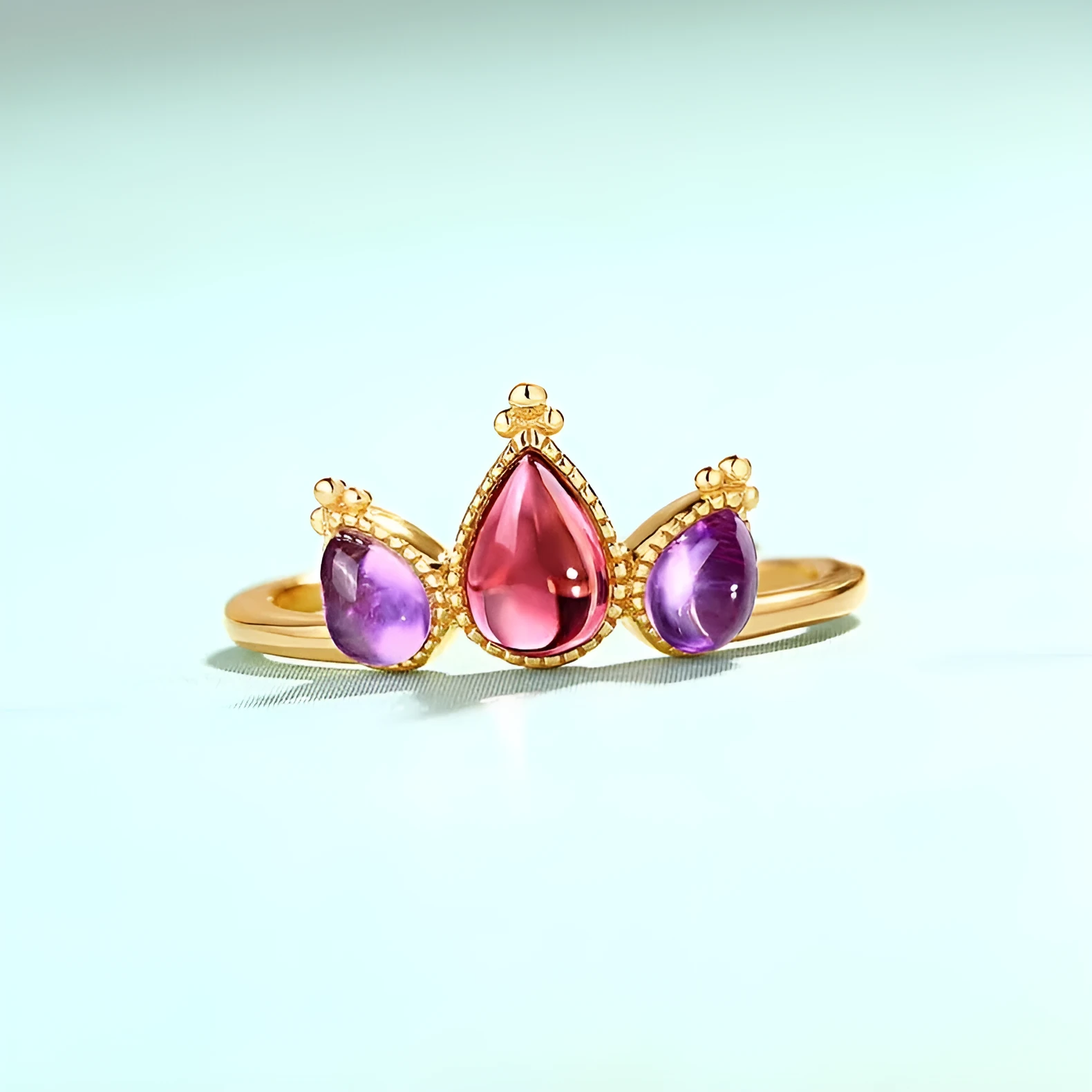 Sterling silver ring with drop-shaped garnet stone on finger, 925 silver, electroplated finish