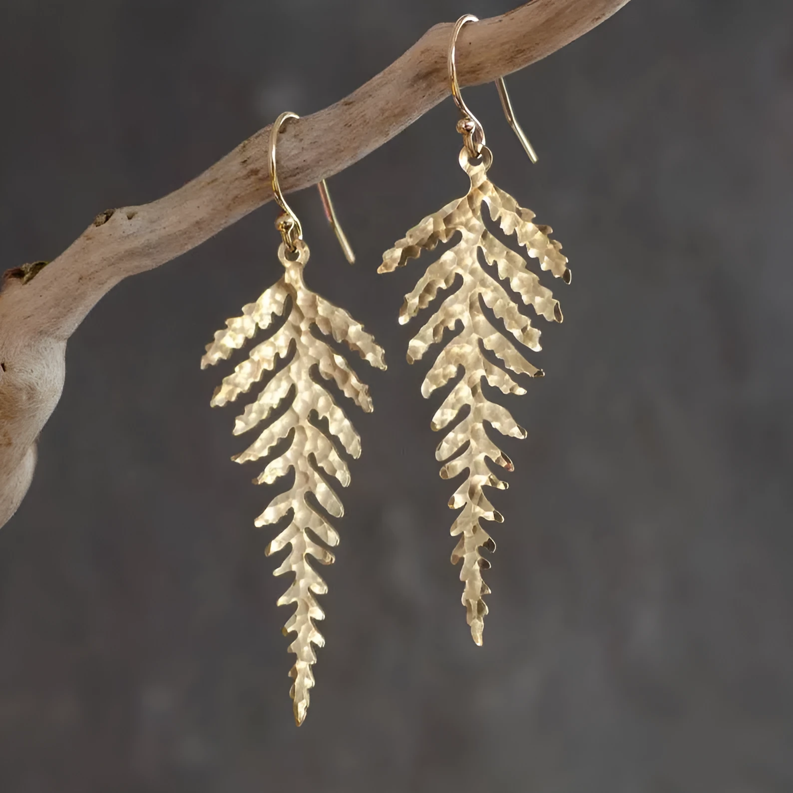 Gold alloy leaf-shaped dangle earrings with a tassel, bohemian style for women.