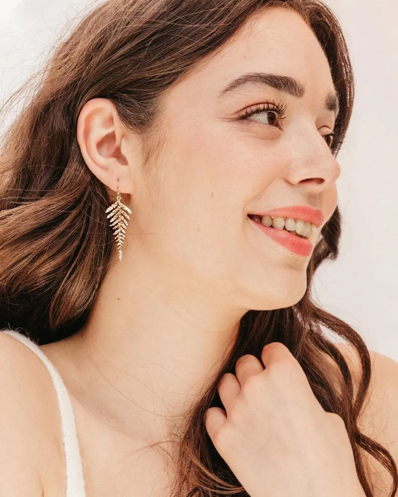 Gold alloy leaf-shaped dangle earrings with a tassel, bohemian style for women.