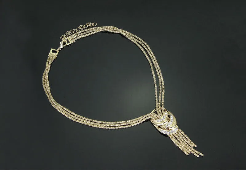 Gold alloy jewelry set with necklace, bracelet, earrings, and ring on a neutral background