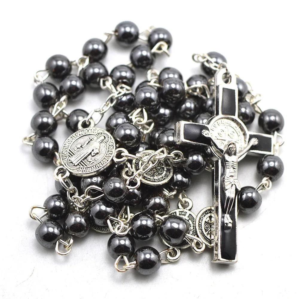 Black rosary necklace with hematite beads and zinc alloy cross on plain background