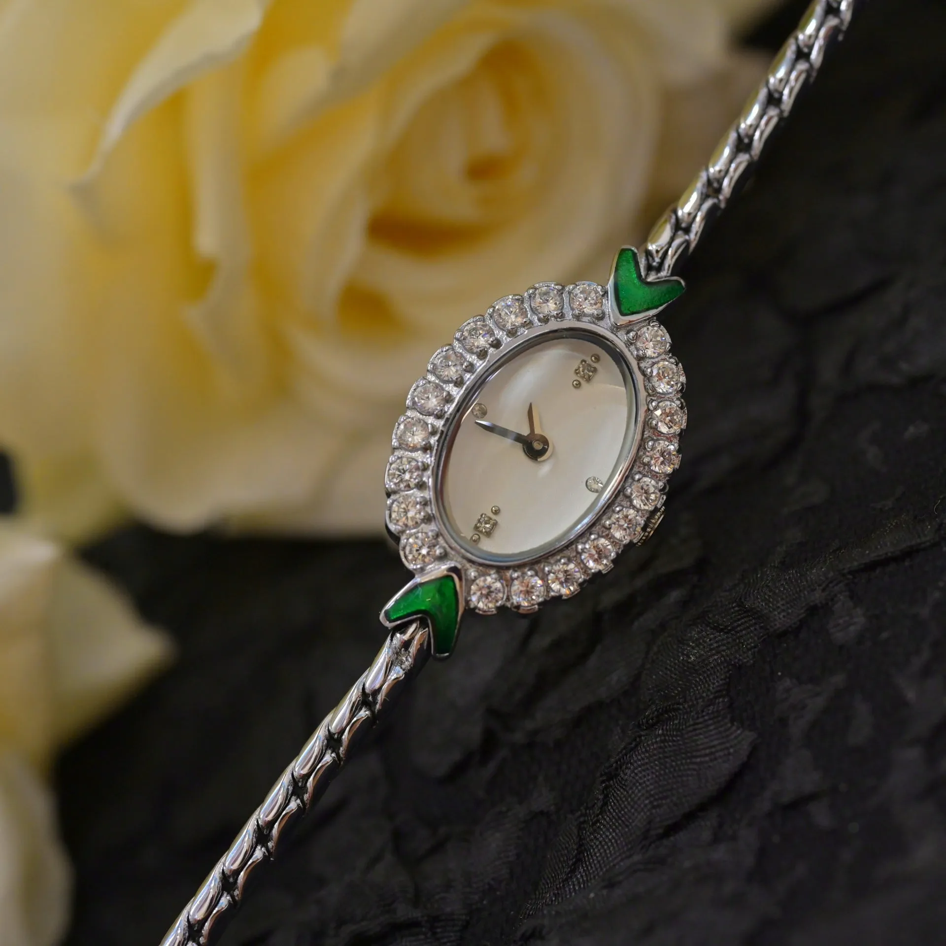 European small gold women's watch with handmade rhinestone inlay on a white background