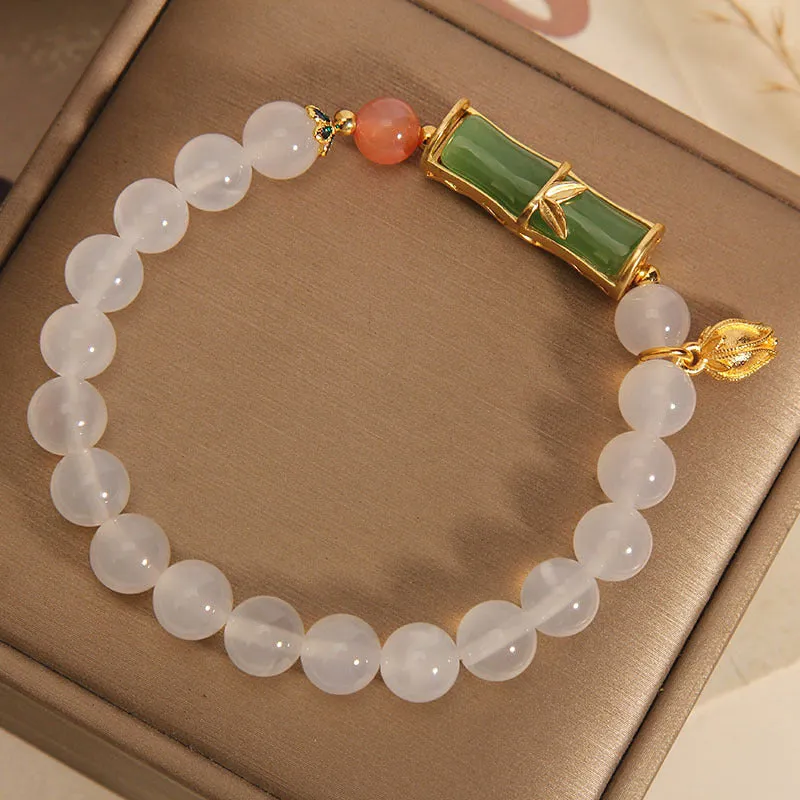 Women's white agate and jade beaded bracelet with bamboo joint connector in retro Chinese style.