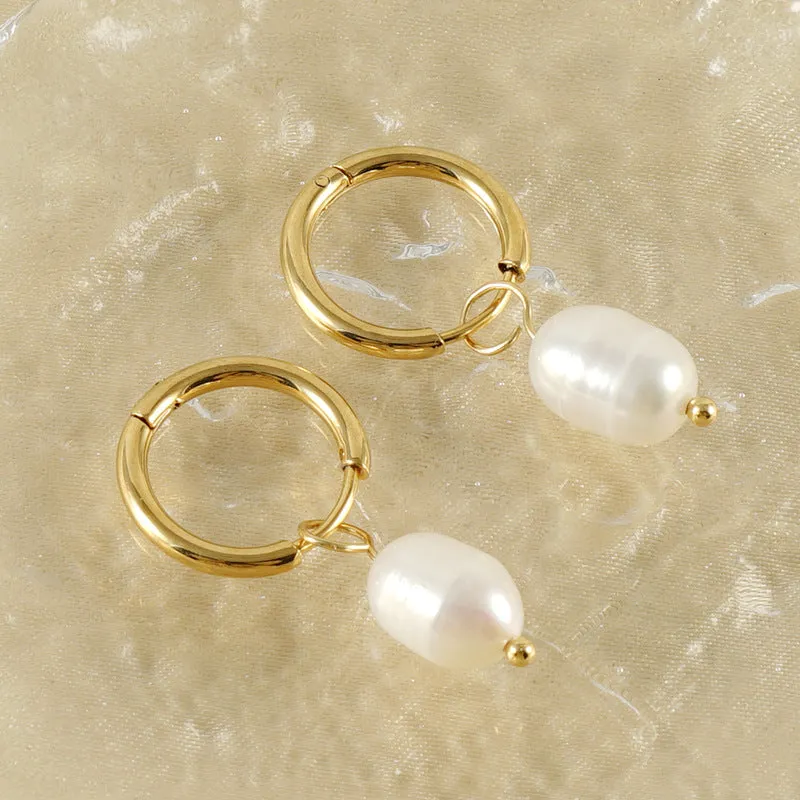 Gold geometric women's drop earrings with a pearl centre on hypoallergenic titanium steel posts.