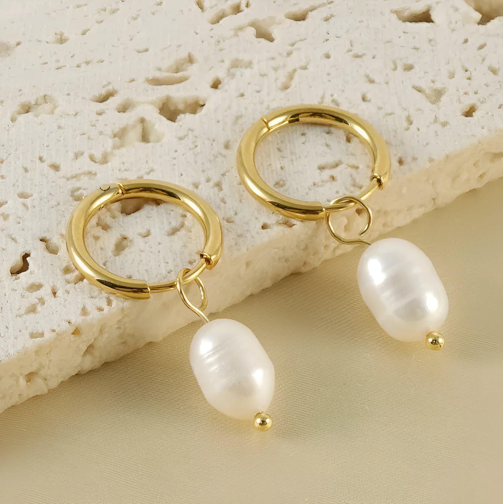 Gold geometric women's drop earrings with a pearl centre on hypoallergenic titanium steel posts.