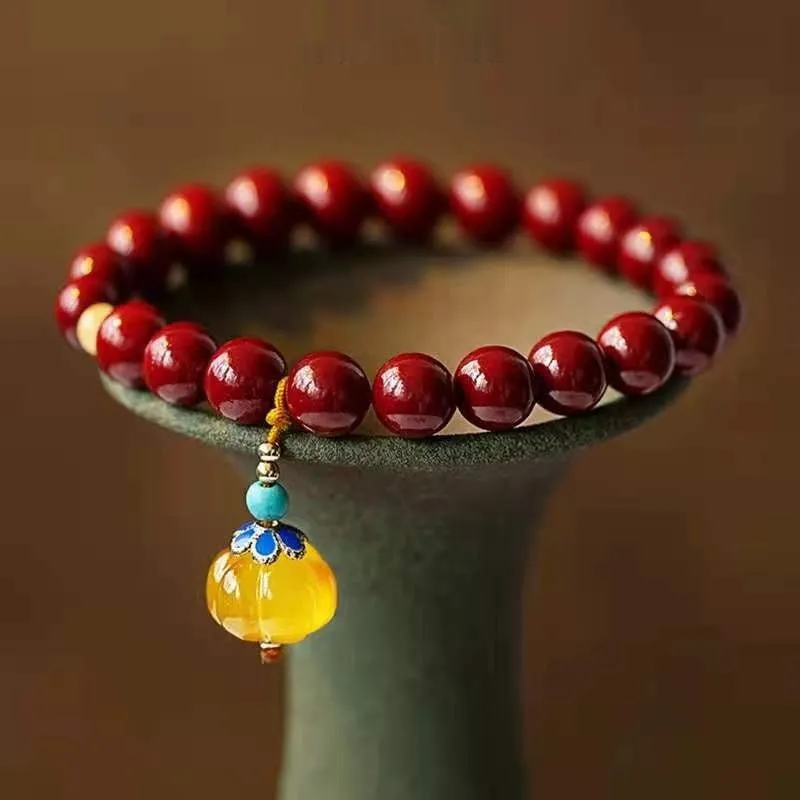 Traditional handmade gold cinnabar wave bracelet with copper bead accents in pumpkin or brand cinnabar colour options