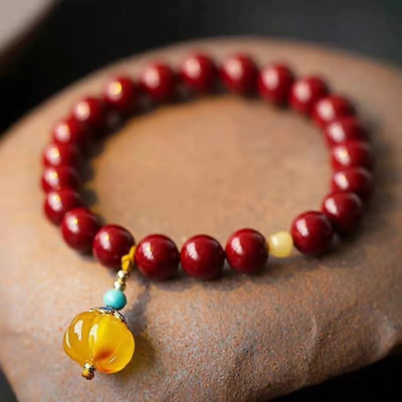 Traditional handmade gold cinnabar wave bracelet with copper bead accents in pumpkin or brand cinnabar colour options