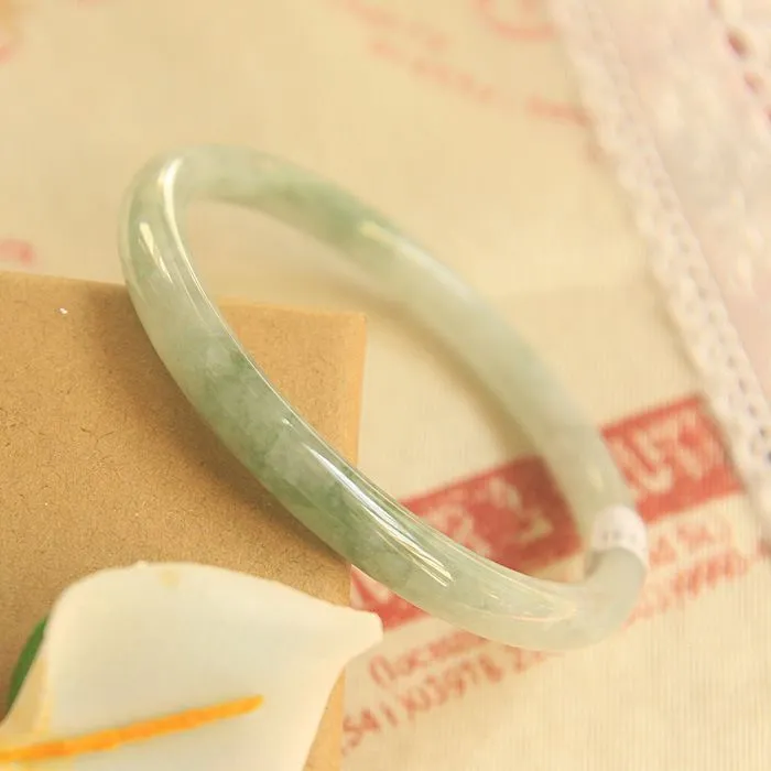 Traditional green jade waxy Chinese bracelet with geometric design showing 10mm profile