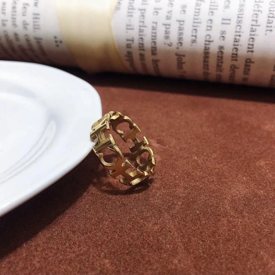 Gold titanium steel hollowed cut letter ring in unisex geometric Korean style, sizes 6-9