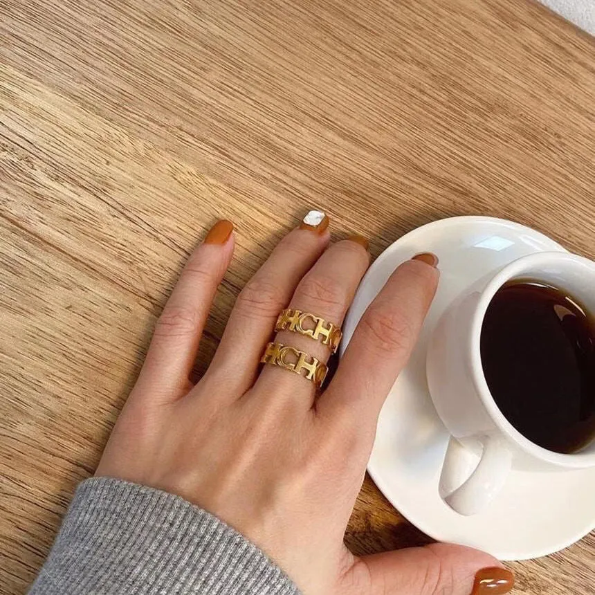 Gold titanium steel hollowed cut letter ring in unisex geometric Korean style, sizes 6-9