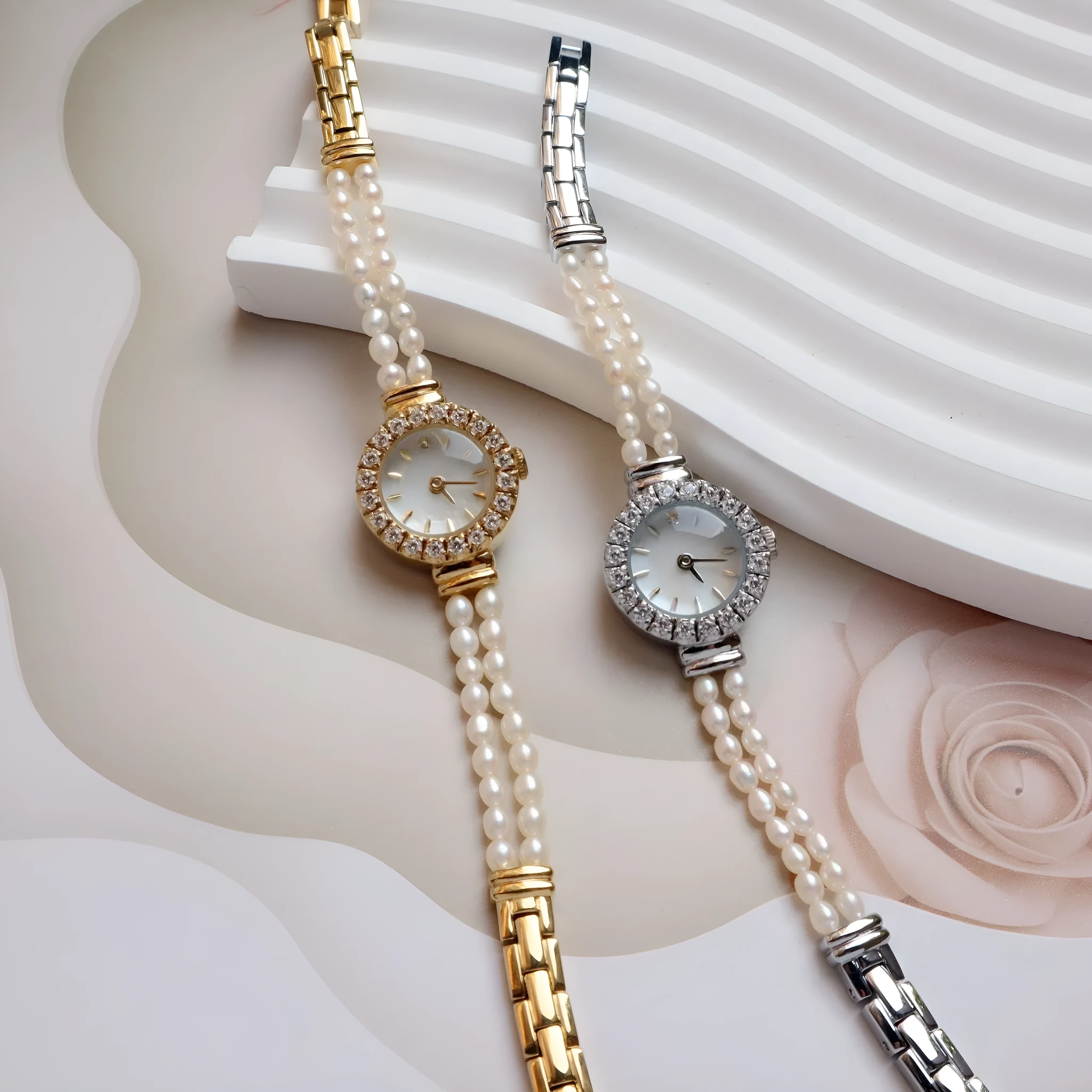 Light gold women's bracelet watch with freshwater pearls, an 18mm round dial, and a stainless steel folding buckle.