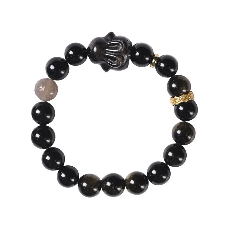 Handmade grey obsidian lying rabbit bracelet with brass and silver details on a wrist, shown in 8mm and 10mm size options.