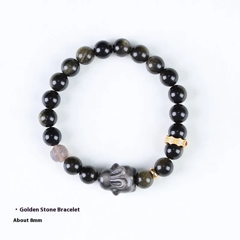 Handmade grey obsidian lying rabbit bracelet with brass and silver details on a wrist, shown in 8mm and 10mm size options.