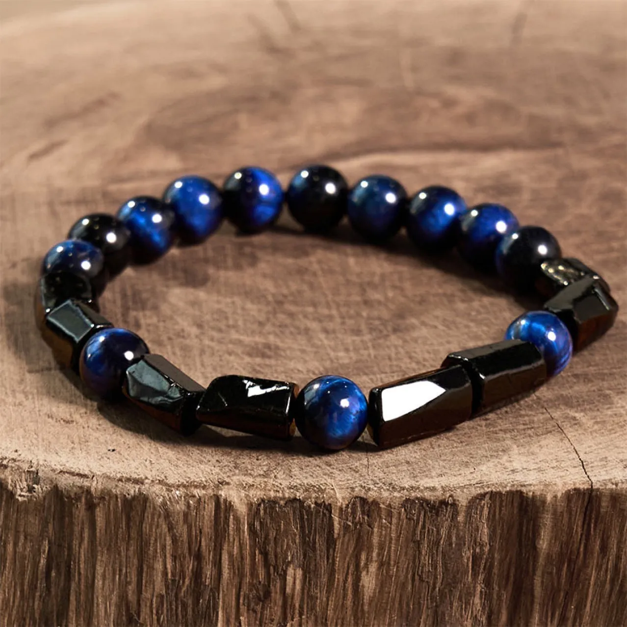Natural obsidian bracelet with constellation design, 8mm wide, on a wrist.