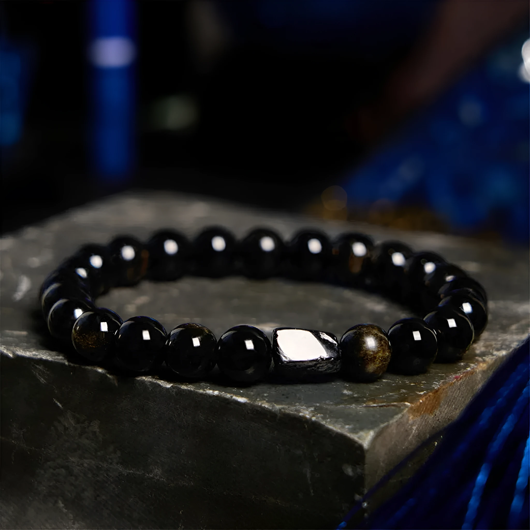 Natural obsidian bracelet with constellation design, 8mm wide, on a wrist.