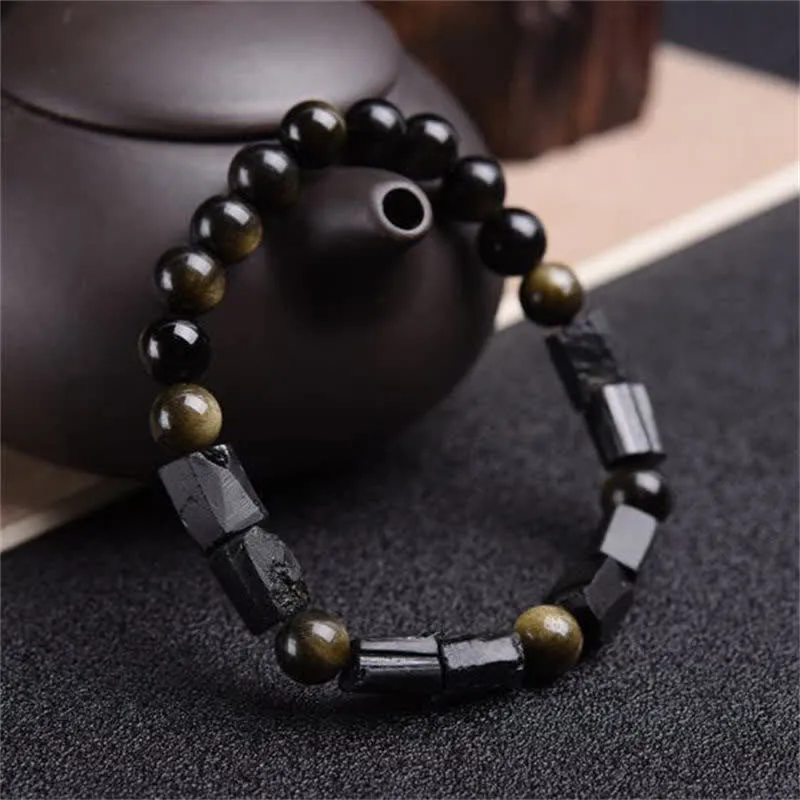 Natural obsidian bracelet with constellation design, 8mm wide, on a wrist.