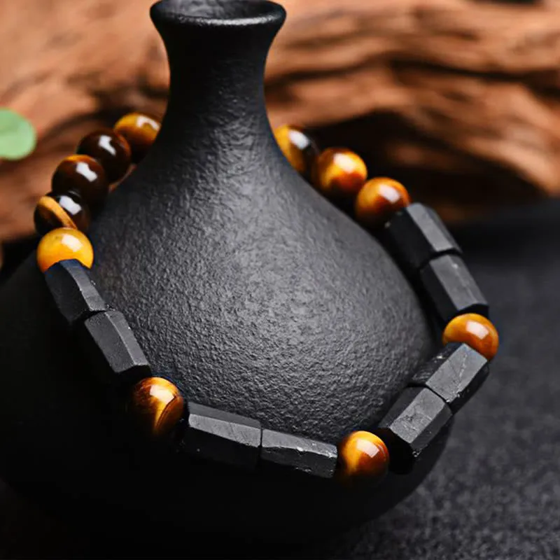 Natural obsidian bracelet with constellation design, 8mm wide, on a wrist.