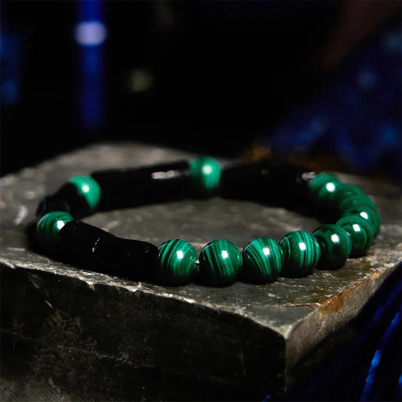Natural obsidian bracelet with constellation design, 8mm wide, on a wrist.