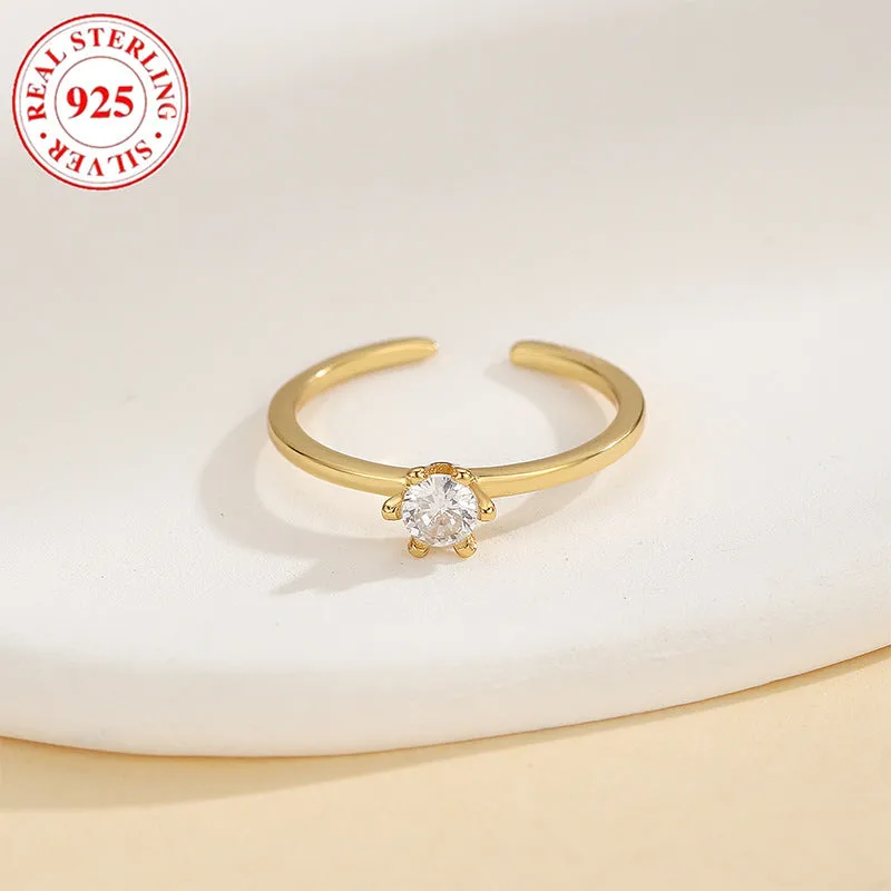 S925 sterling silver adjustable toe ring with gold F048 finish and single zircon inlay on white background