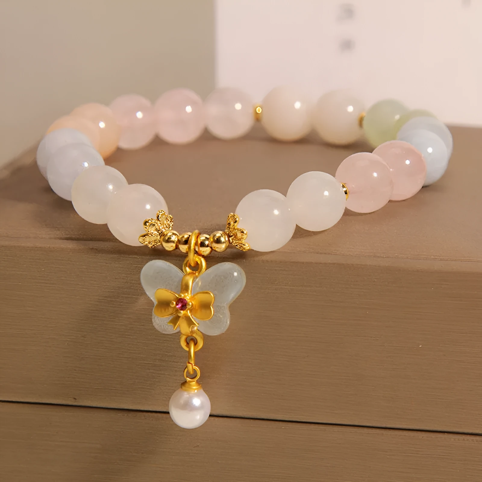 Women's crystal bracelet with butterfly pendant featuring natural morganite stones in candy colours