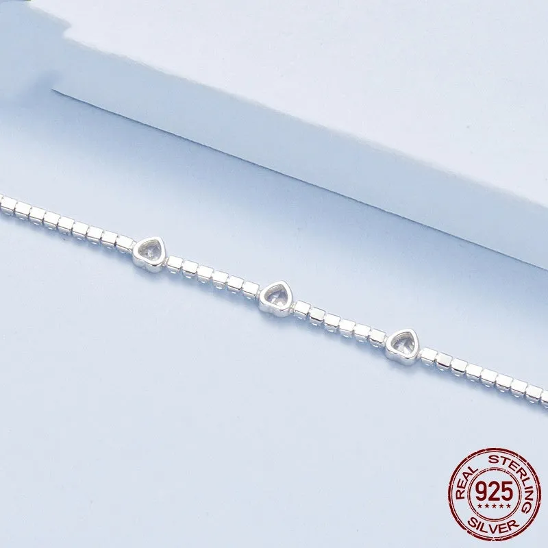 S925 sterling silver bracelet with heart-shaped clear zircon centrepiece on light background