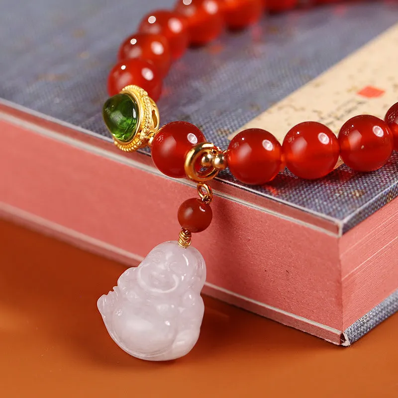 Chinese style geometric women's bracelet with red agate beads and a gold jade Maitreya Buddha pendant.