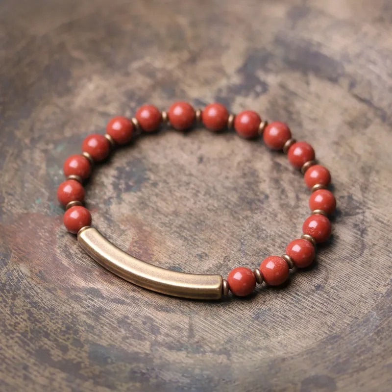 Layered retro bracelet with natural stone beads and brass details on a wrist.