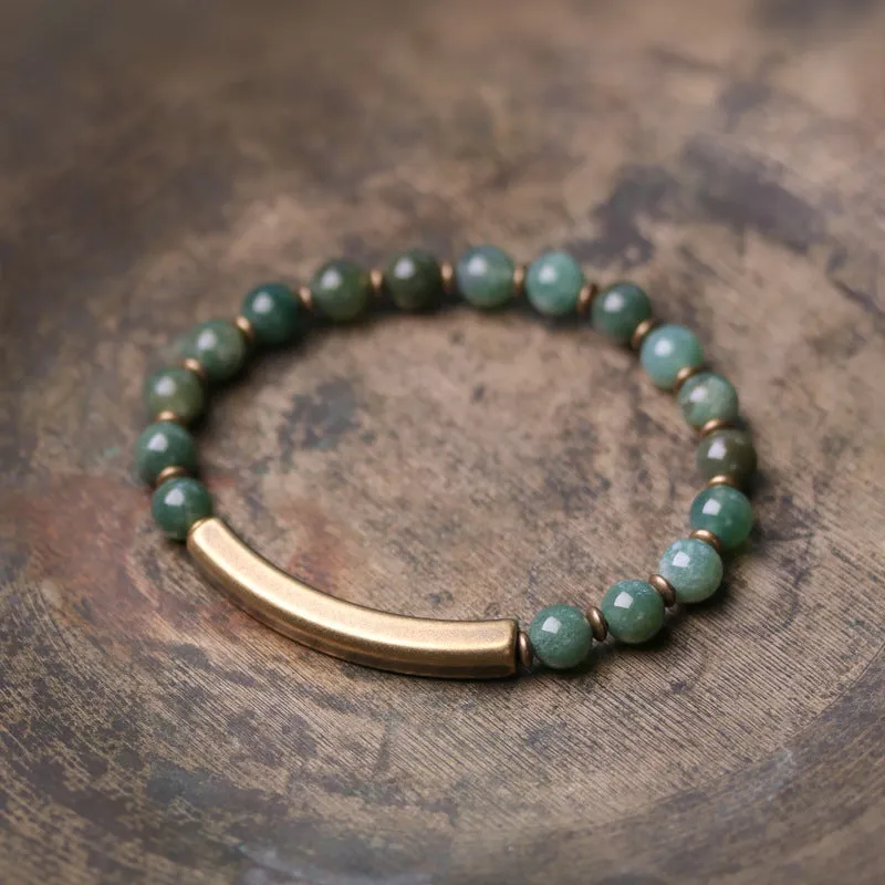 Layered retro bracelet with natural stone beads and brass details on a wrist.