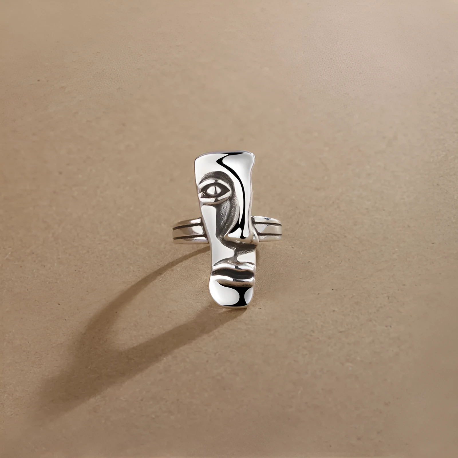 Copper retro half face mask ring with electroplated finish and adjustable opening on a neutral background.
