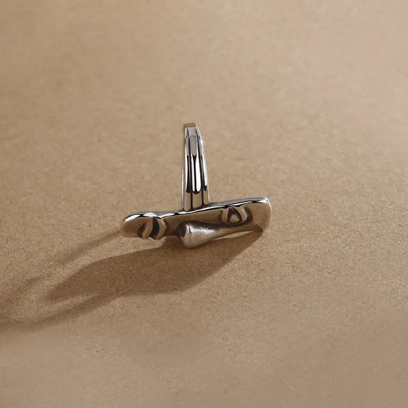 Copper retro half face mask ring with electroplated finish and adjustable opening on a neutral background.