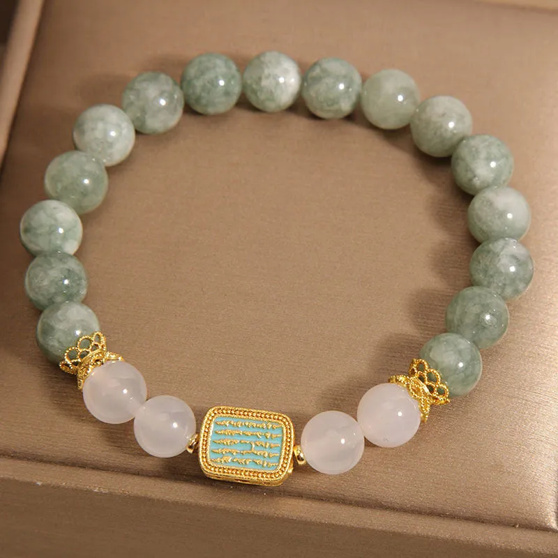 Women's oil green emerald crystal bracelet with five natural gemstones on a wrist.
