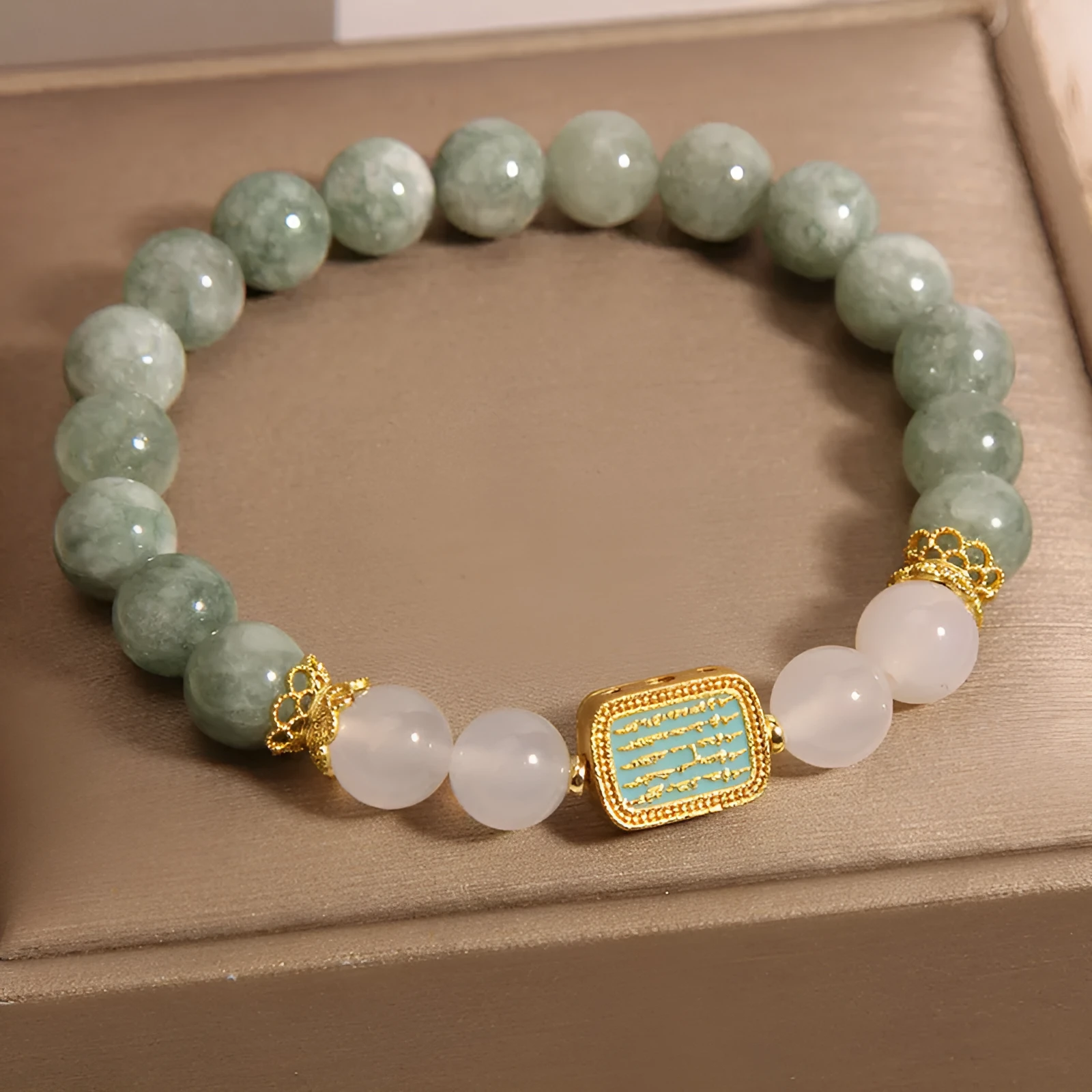 Women's oil green emerald crystal bracelet with five natural gemstones on a wrist.