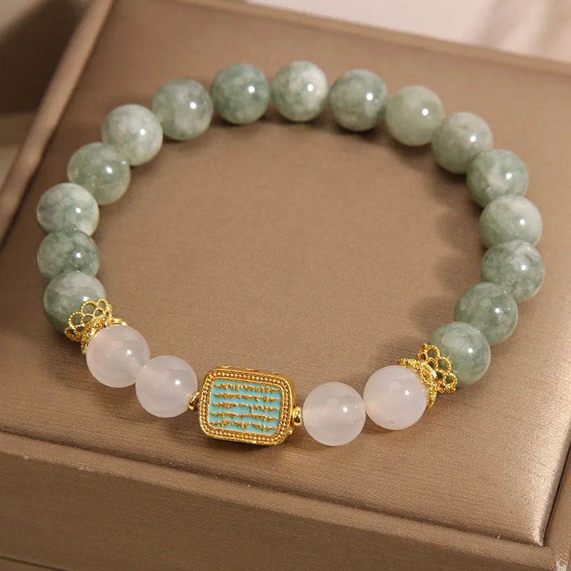 Women's oil green emerald crystal bracelet with five natural gemstones on a wrist.