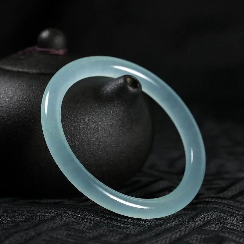Women's jade bracelet with ice-like emerald appearance and floating flower patterns in multiple colour options