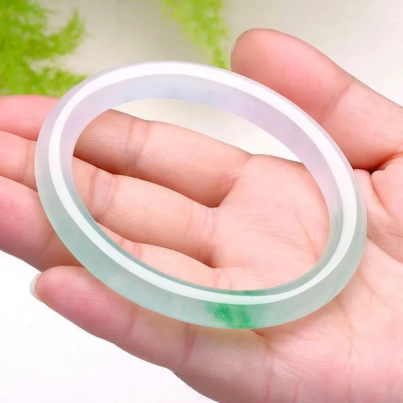 Women's jade bracelet with ice-like emerald appearance and floating flower patterns in multiple colour options
