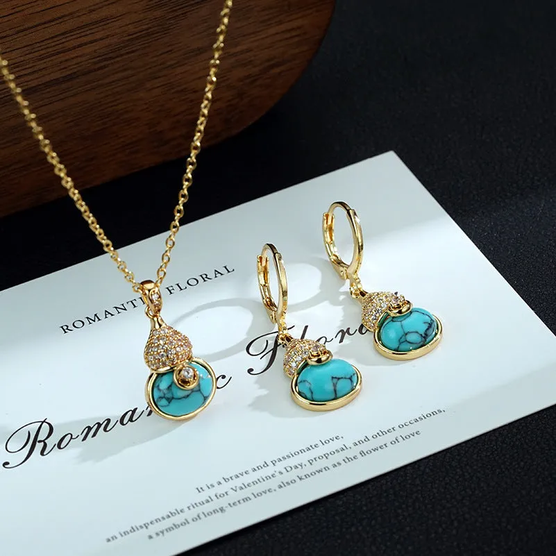 Turquoise gourd flower shape earrings and necklace set on display showing 18K gold plated brass finish