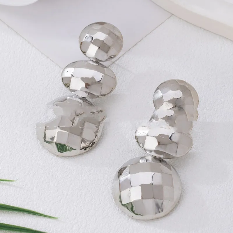 Retro women's polka dot metal bead drop earrings in frosted gold finish on a neutral background