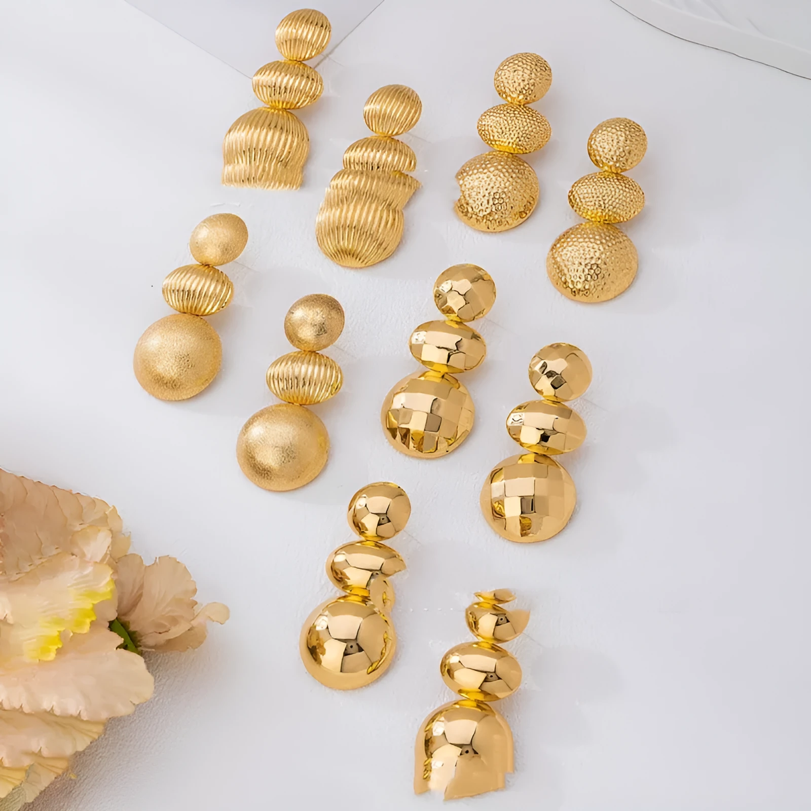 Retro women's polka dot metal bead drop earrings in frosted gold finish on a neutral background