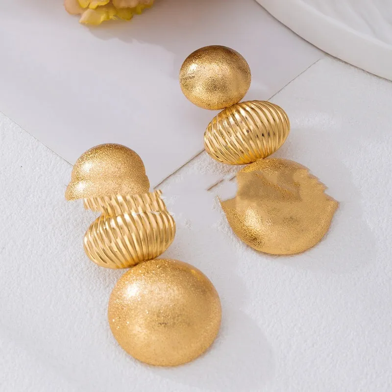 Retro women's polka dot metal bead drop earrings in frosted gold finish on a neutral background