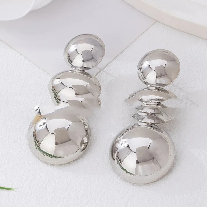 Retro women's polka dot metal bead drop earrings in frosted gold finish on a neutral background