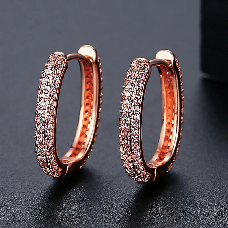 Pair of simple geometric copper earrings with electroplated finish in 18K gold option on white background