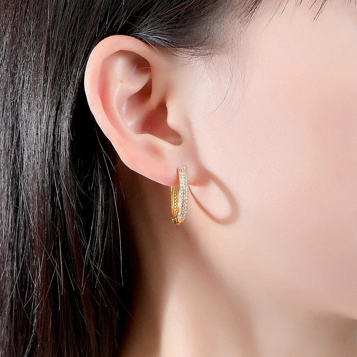 Pair of simple geometric copper earrings with electroplated finish in 18K gold option on white background