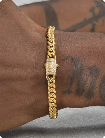 8mm gold titanium steel Cuban bracelet on display with alloy gemstone inlay