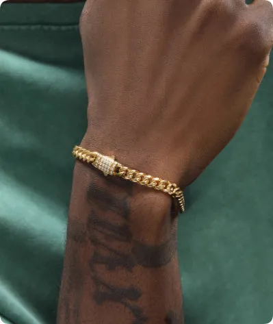 8mm gold titanium steel Cuban bracelet on display with alloy gemstone inlay