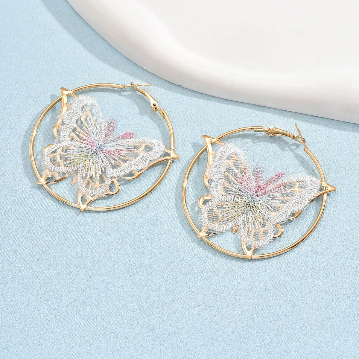 Gold butterfly clip-on earrings for women with geometric design and iron construction